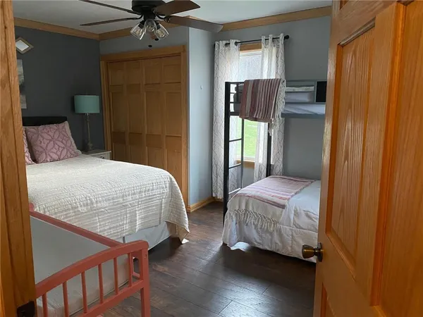 a bedroom with bed and wooden floor