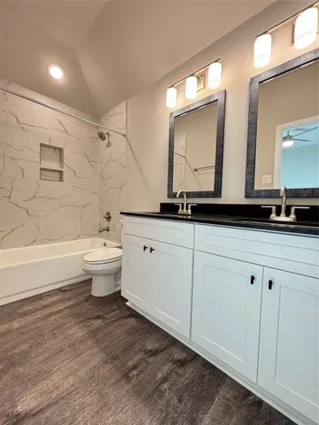 a bathroom with double sink and a mirror