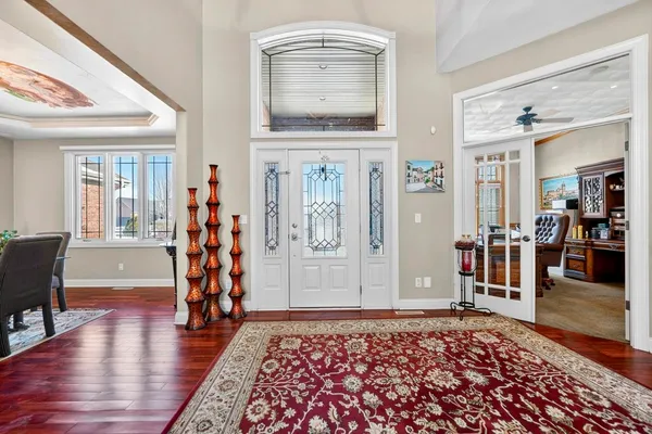 a bedroom with a bed and dresser with the outer view