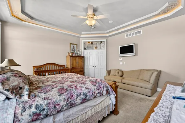 a bedroom with a bed and a chandelier