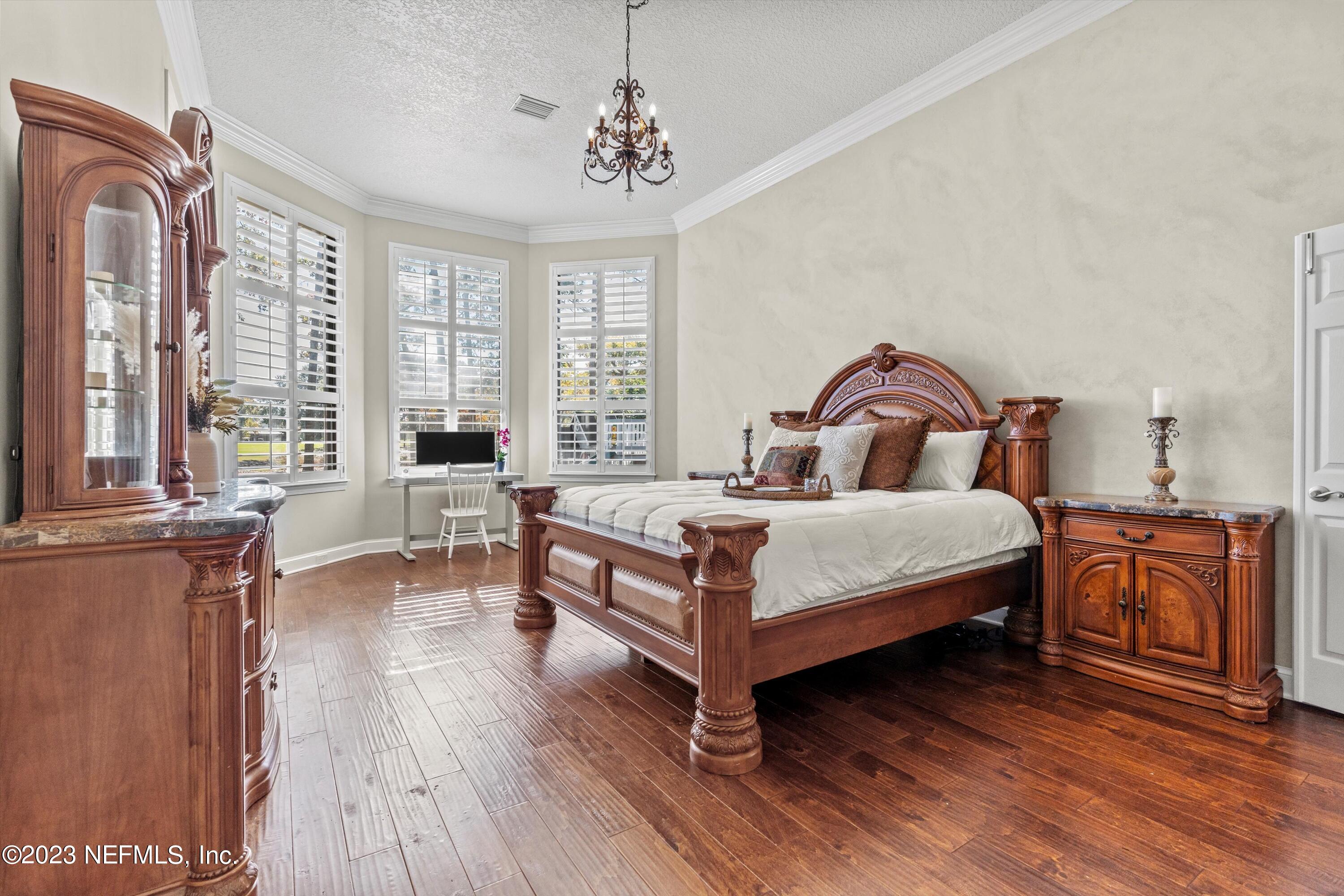 13062 Biggin Church Road South Jacksonville, FL 32224 - Photo 14 of 56 a bedroom with a bed and large windows
