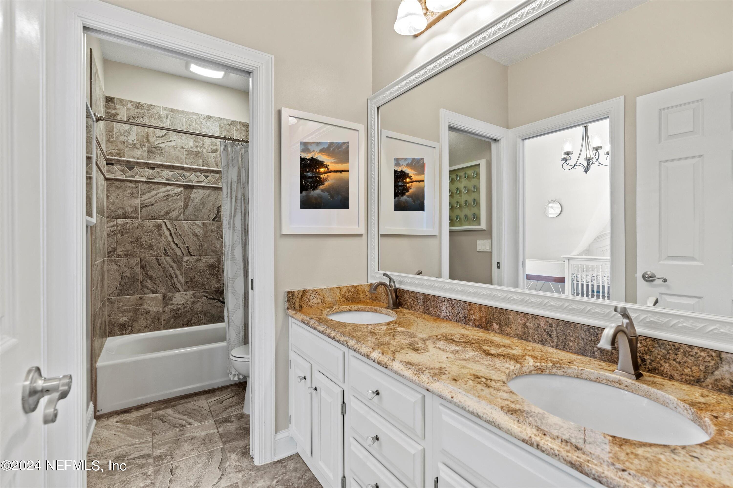 13062 Biggin Church Road South Jacksonville, FL 32224 - Photo 20 of 56 a bathroom with a granite countertop sink mirror and shower