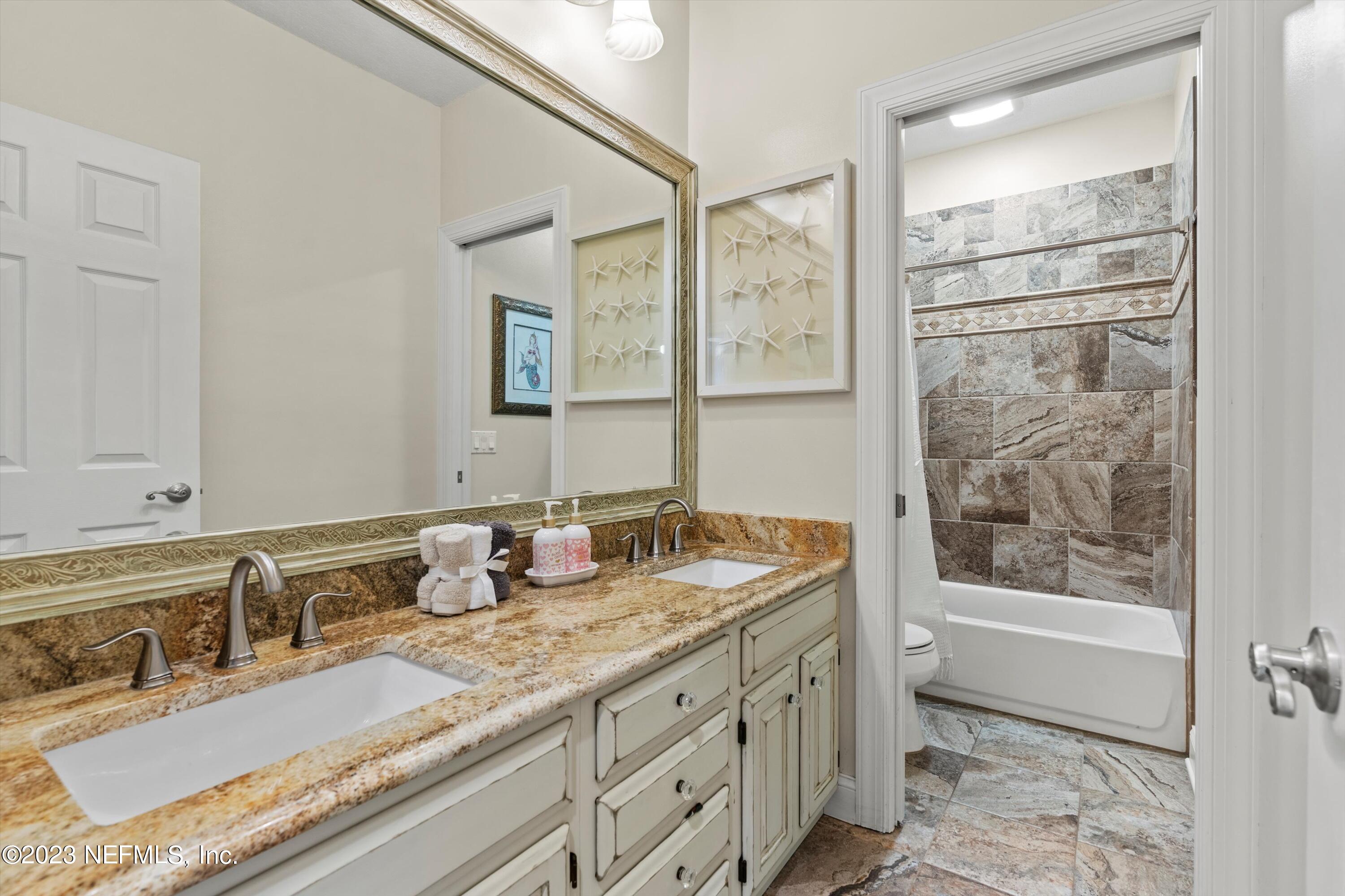 13062 Biggin Church Road South Jacksonville, FL 32224 - Photo 22 of 56 a bathroom with a granite countertop sink mirror and double