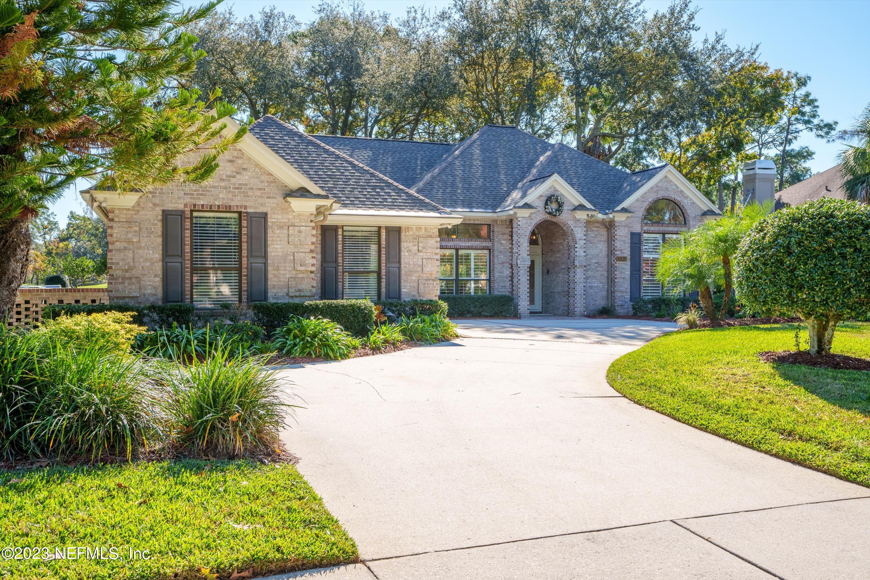 13062 Biggin Church Road South Jacksonville, FL 32224 - Photo 55 of 56 a front view of a house with a garden and trees