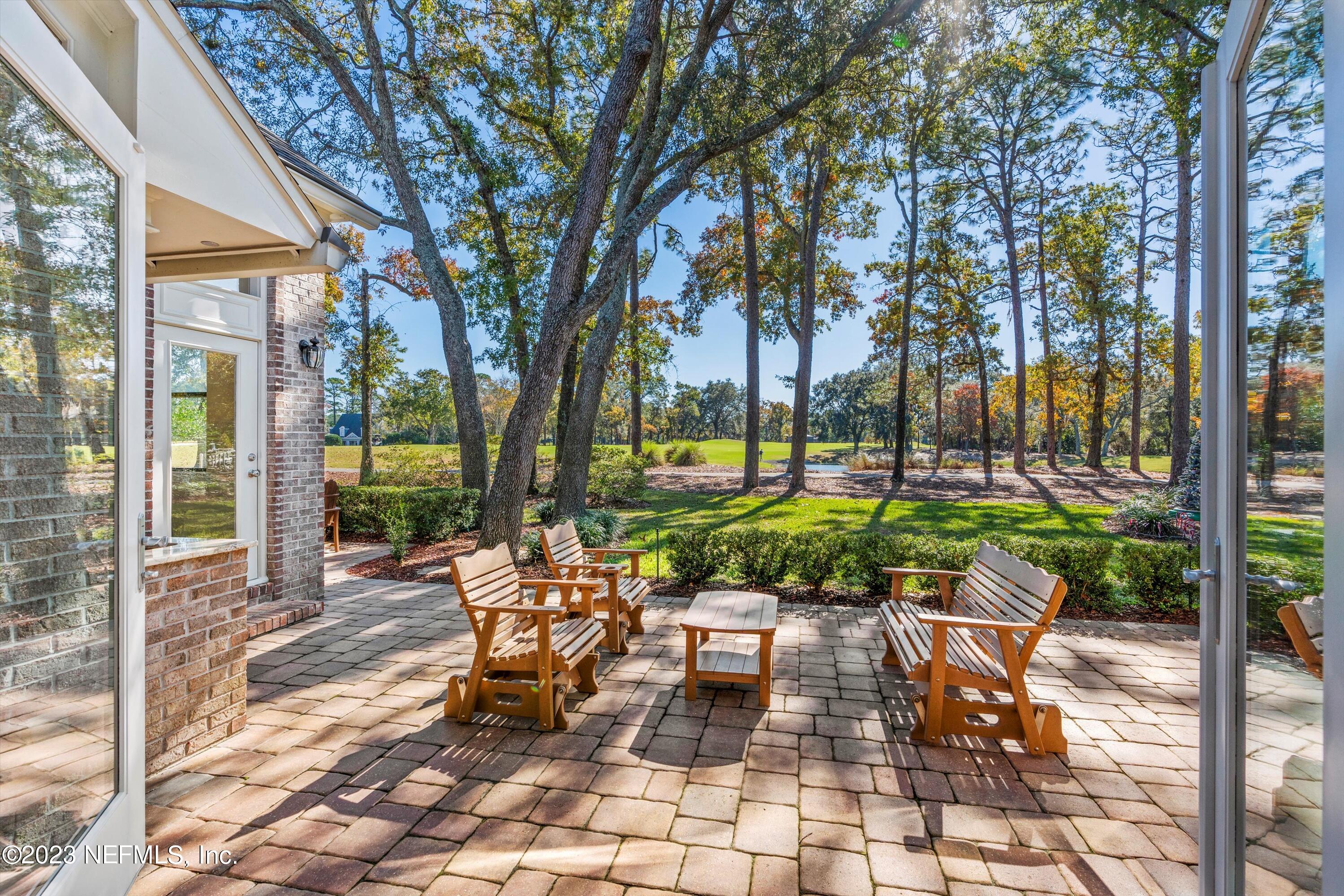 13062 Biggin Church Road South Jacksonville, FL 32224 - Photo 6 of 56 a view of a patio with table and chairs and floor to ceiling window