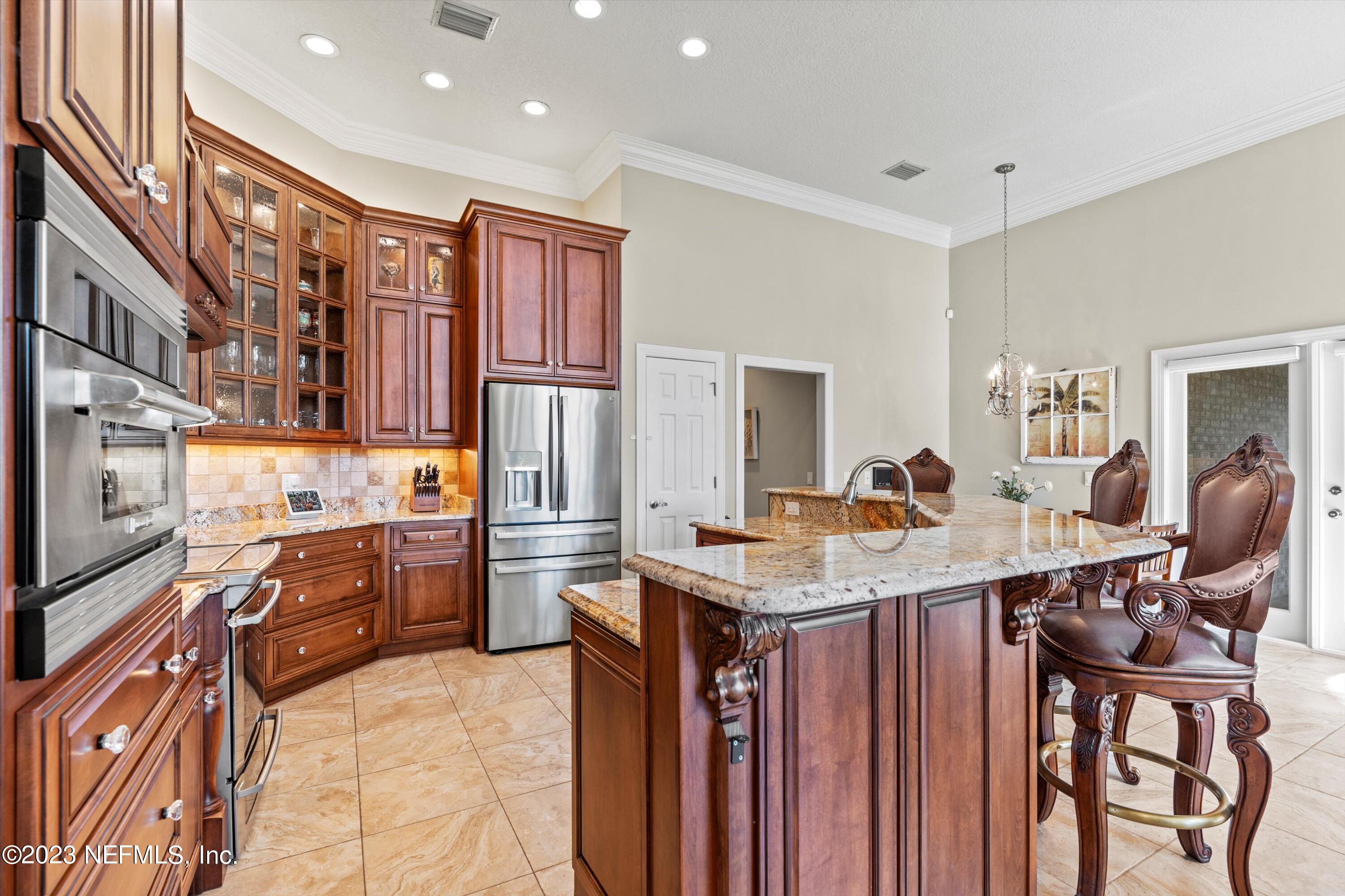 13062 Biggin Church Road South Jacksonville, FL 32224 - Photo 7 of 56 a kitchen with stainless steel appliances granite countertop a stove top oven a sink dishwasher and cabinets with wooden floor