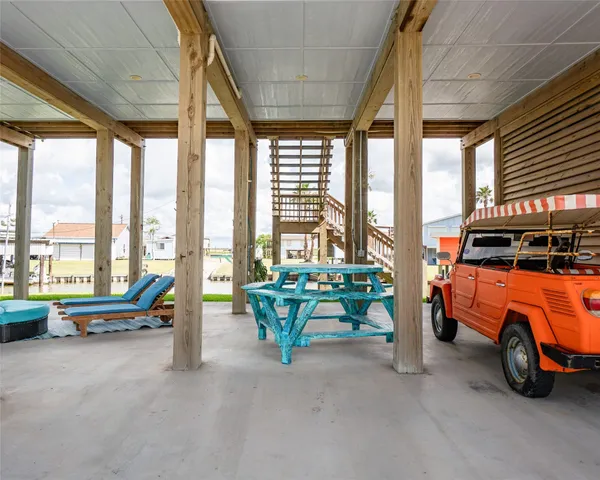 a living room with furniture and floor to ceiling window