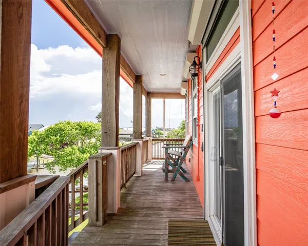 a view of balcony with wooden floor and furniture