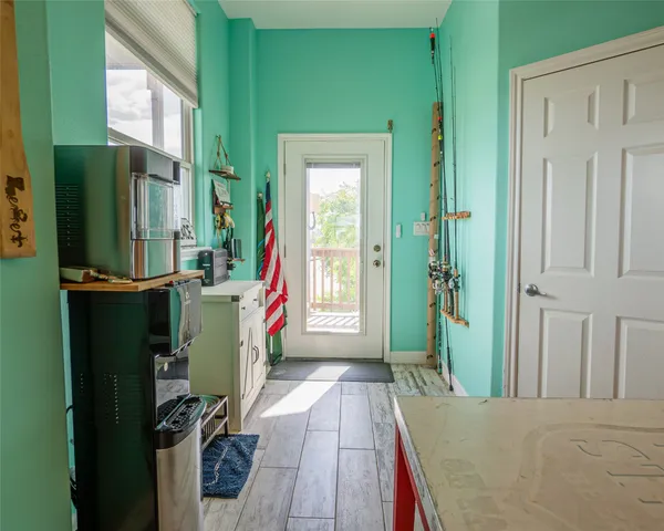 a view of an entryway with wooden floor
