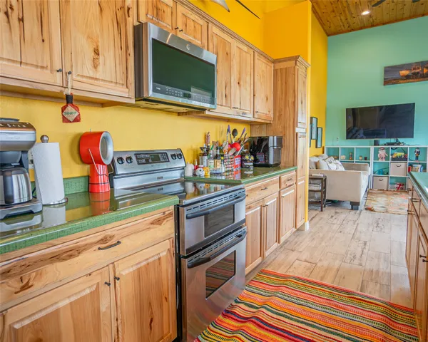 a kitchen with stainless steel appliances granite countertop a sink dishwasher stove microwave and cabinets