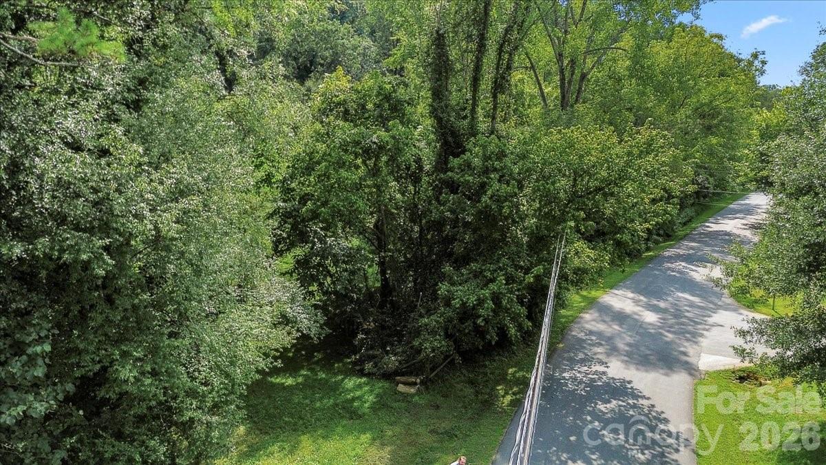 0 Bell Street Mount Holly, NC 28120 - Photo 4 of 10 a view of a yard with plants and large trees