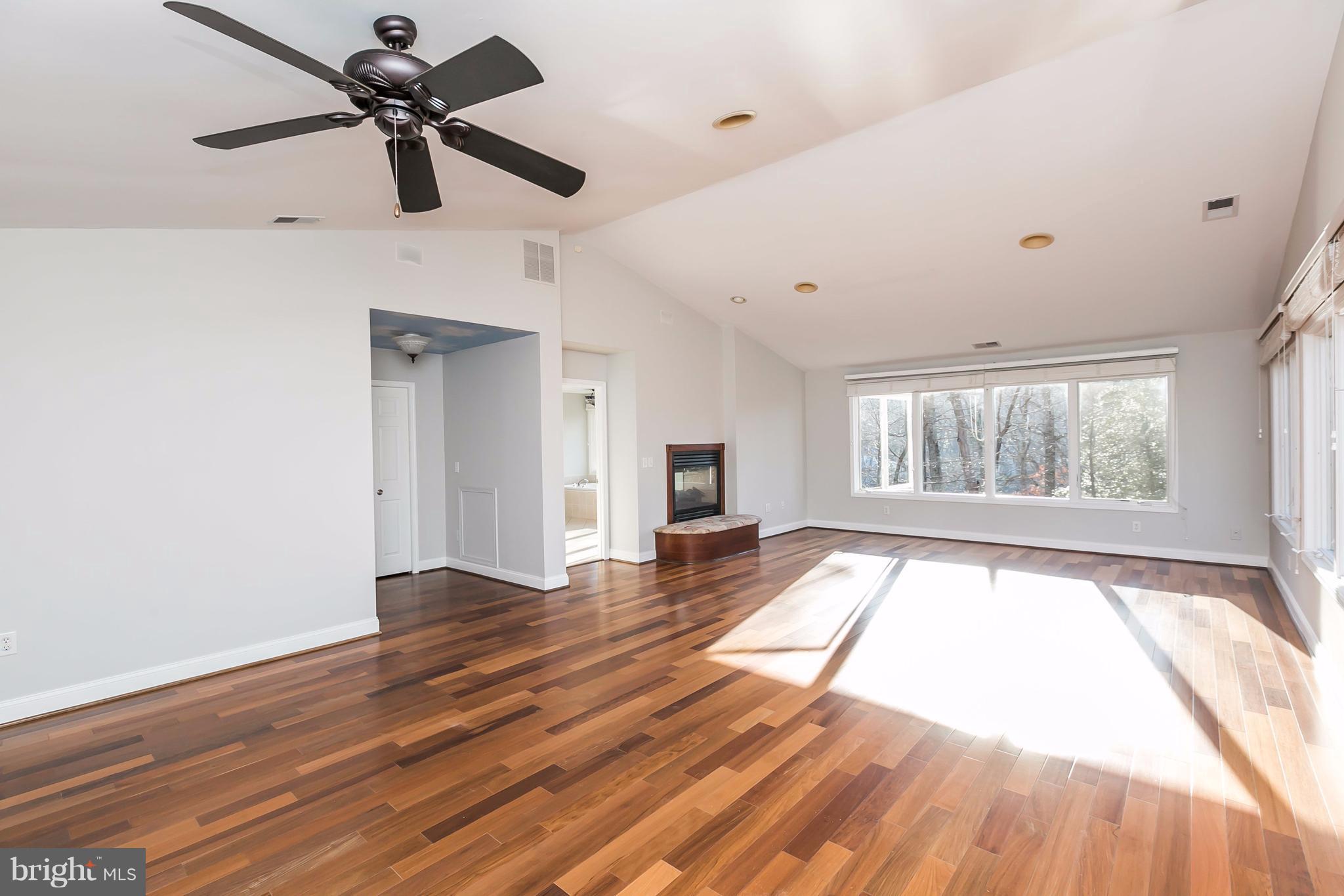 126 Gilbert Court Edgewater, MD 21037 - Photo 14 of 30 a view of an empty room with a window and wooden floor