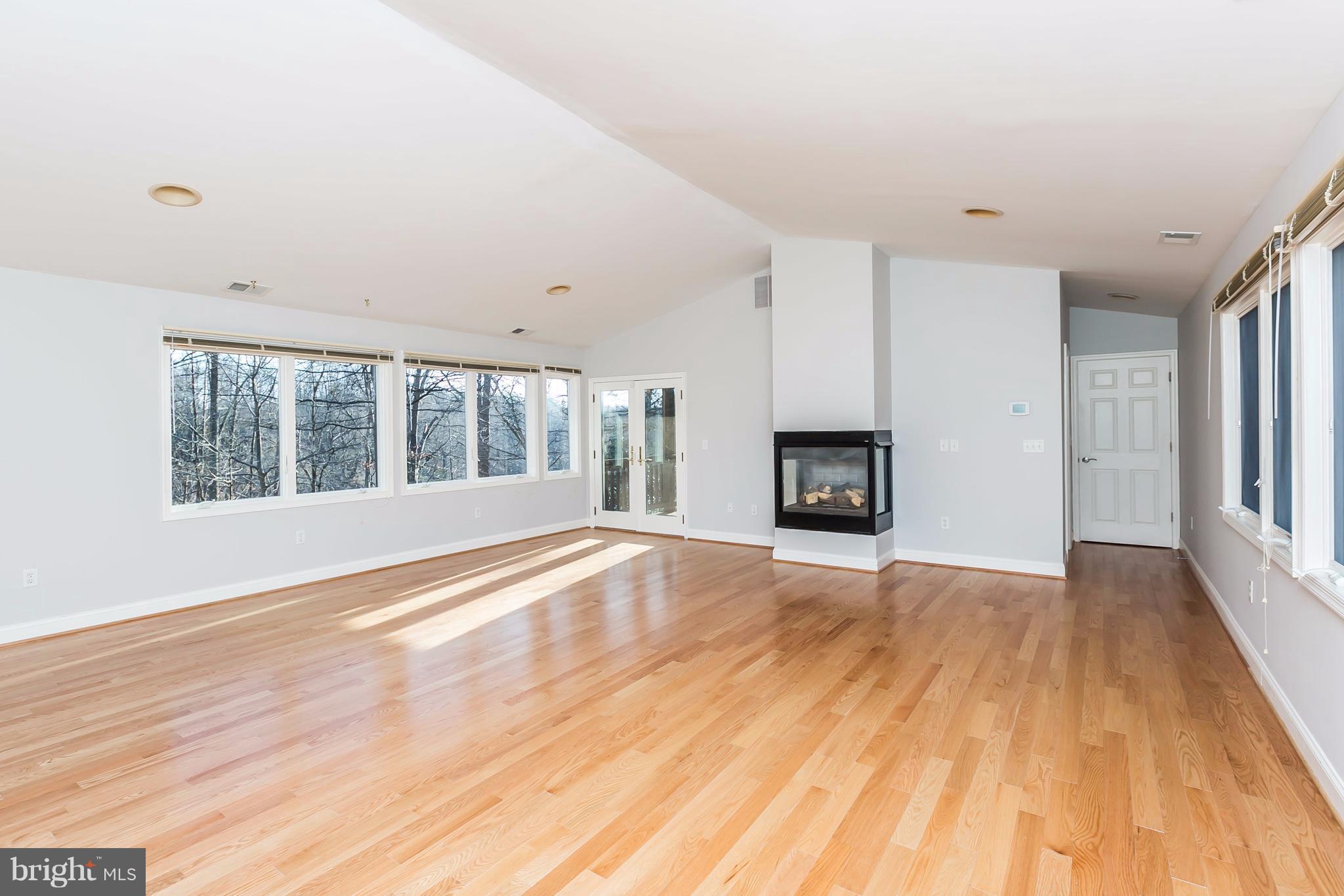 126 Gilbert Court Edgewater, MD 21037 - Photo 19 of 30 a view of an empty room with wooden floor and a window