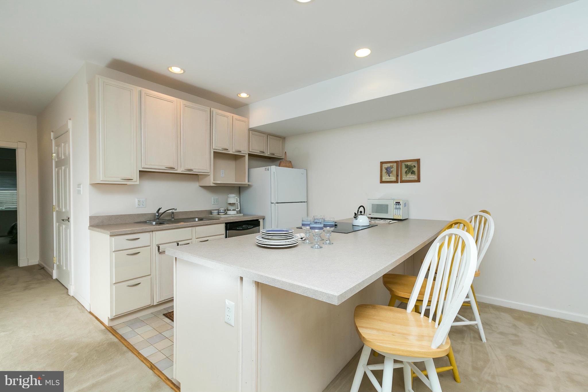 126 Gilbert Court Edgewater, MD 21037 - Photo 23 of 30 a view of kitchen with cabinets dining table and chairs