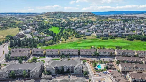 an aerial view of residential houses with outdoor space and trees