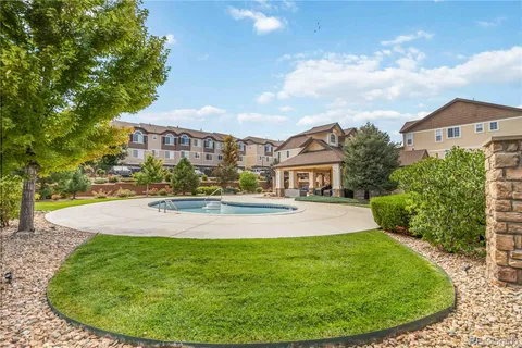 a front view of a house with swimming pool and porch