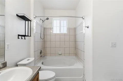 a bathroom with a toilet and a bath tub