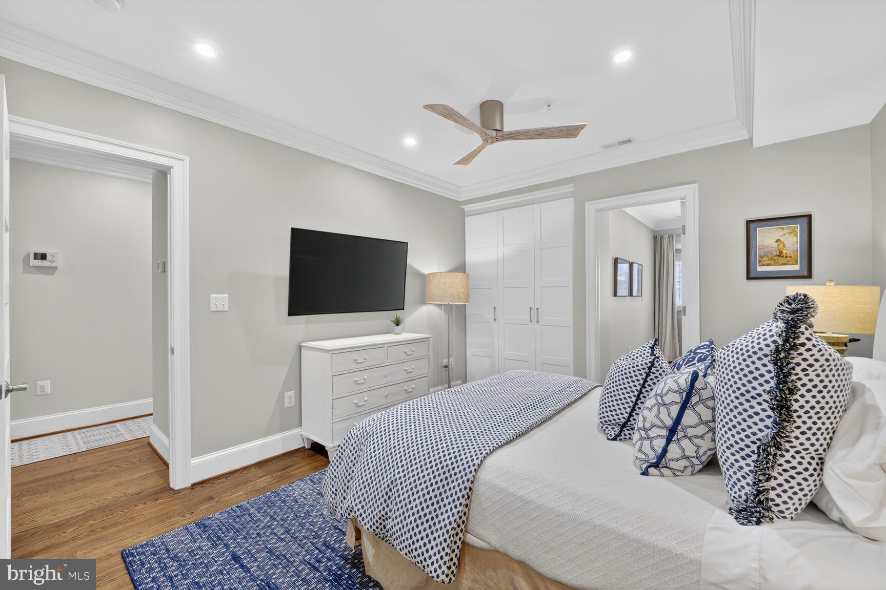 2446 Ontario Road Northwest, Unit 4 Washington, DC 20009 - Photo 14 of 65 a bedroom with a bed and a flat screen tv