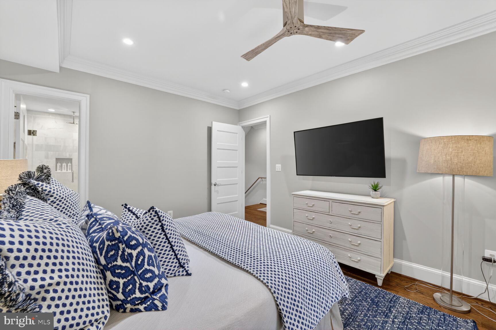 2446 Ontario Road Northwest, Unit 4 Washington, DC 20009 - Photo 15 of 65 a bedroom with a bed and a flat screen tv