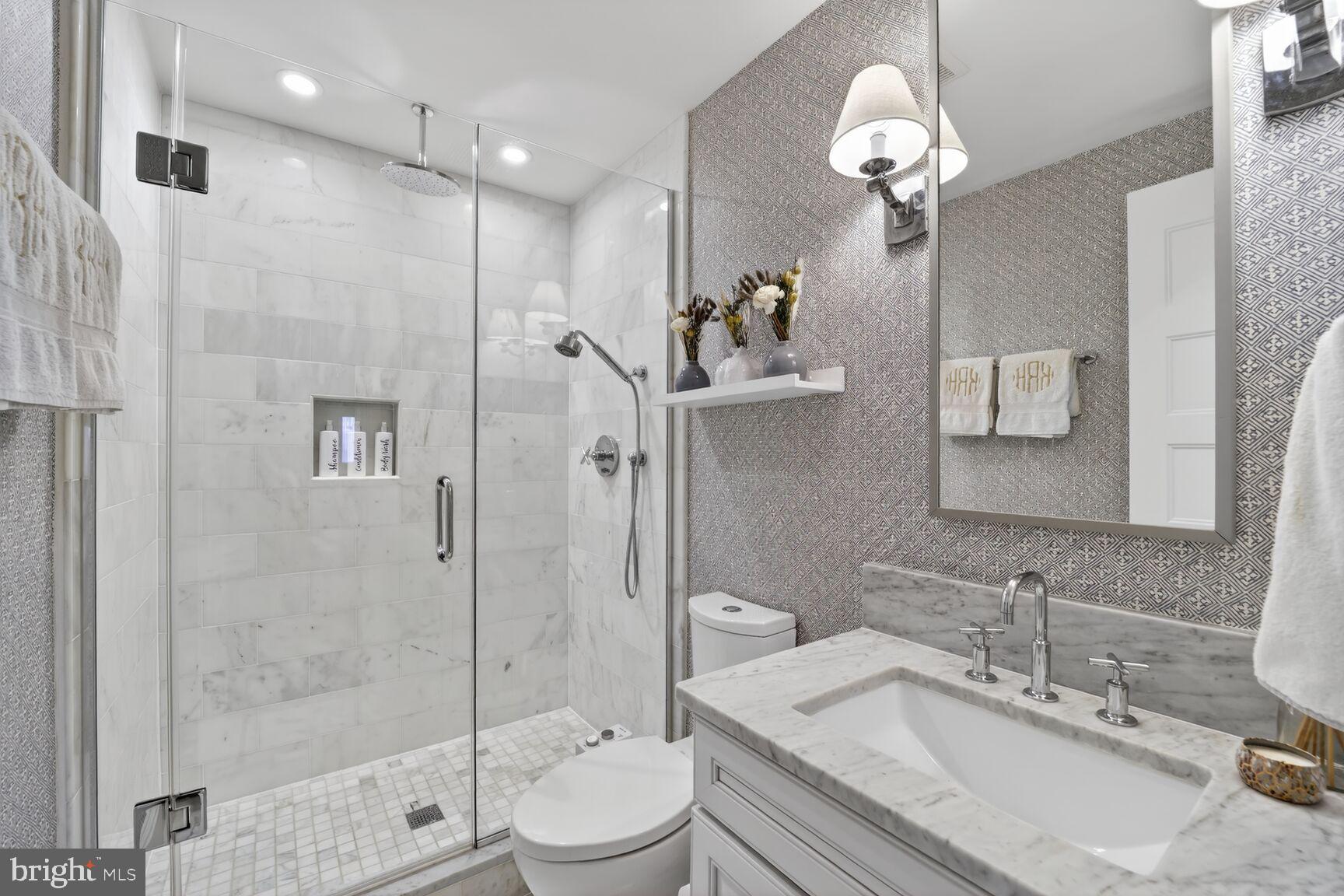 2446 Ontario Road Northwest, Unit 4 Washington, DC 20009 - Photo 16 of 65 a bathroom with a granite countertop sink a toilet and shower