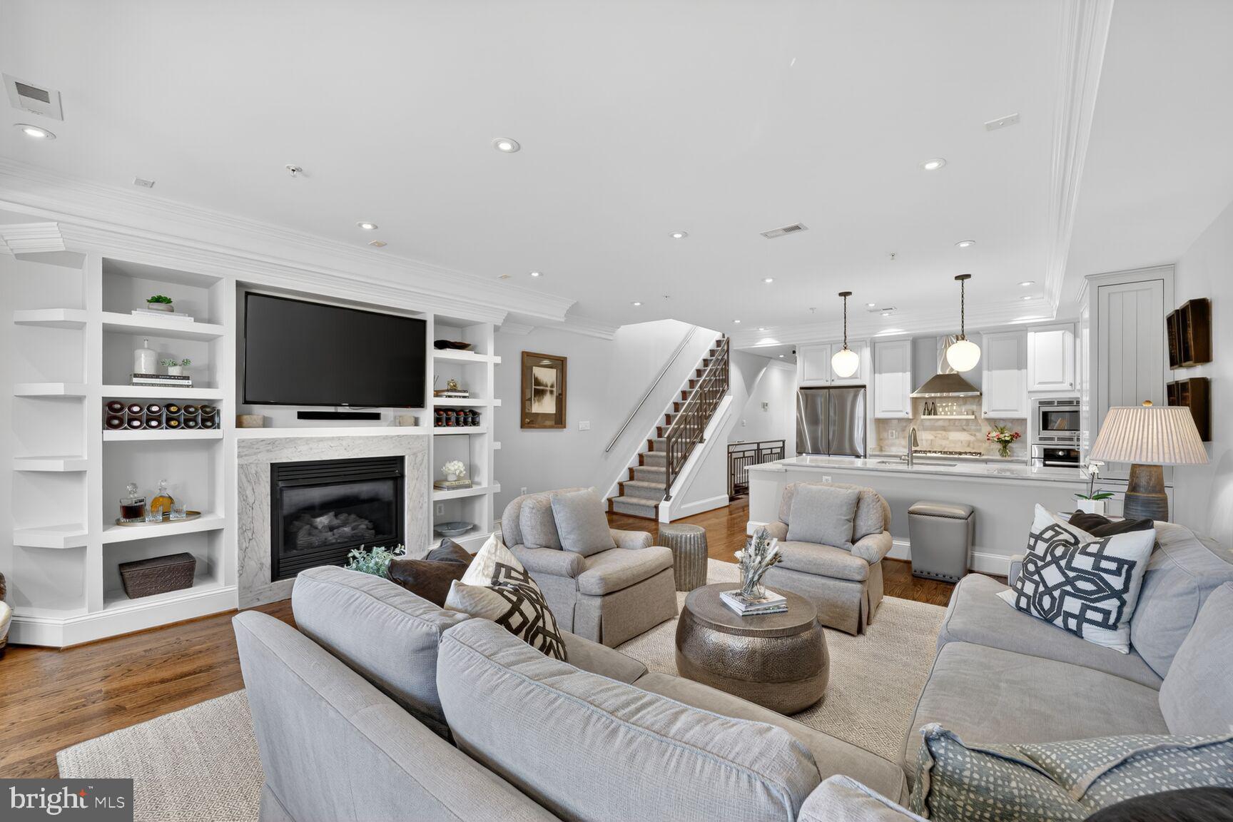 2446 Ontario Road Northwest, Unit 4 Washington, DC 20009 - Photo 2 of 65 a living room with furniture a fireplace and a flat screen tv