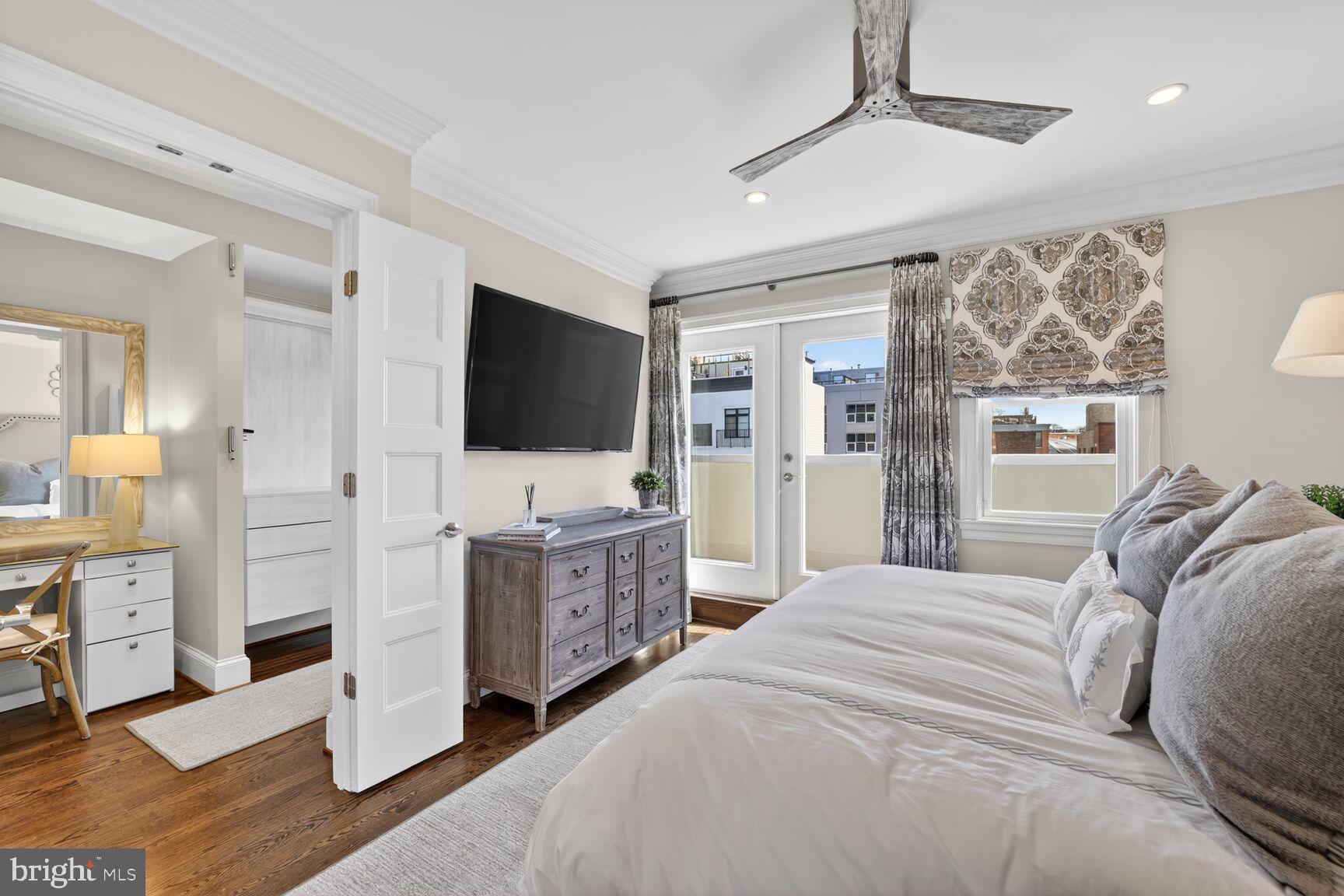 2446 Ontario Road Northwest, Unit 4 Washington, DC 20009 - Photo 25 of 65 a bedroom with furniture and a flat screen tv