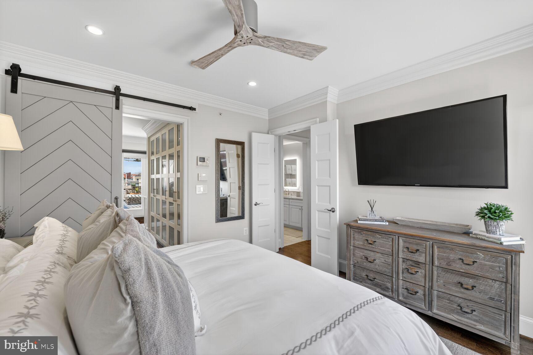 2446 Ontario Road Northwest, Unit 4 Washington, DC 20009 - Photo 26 of 65 a bedroom with a bed and a flat screen tv