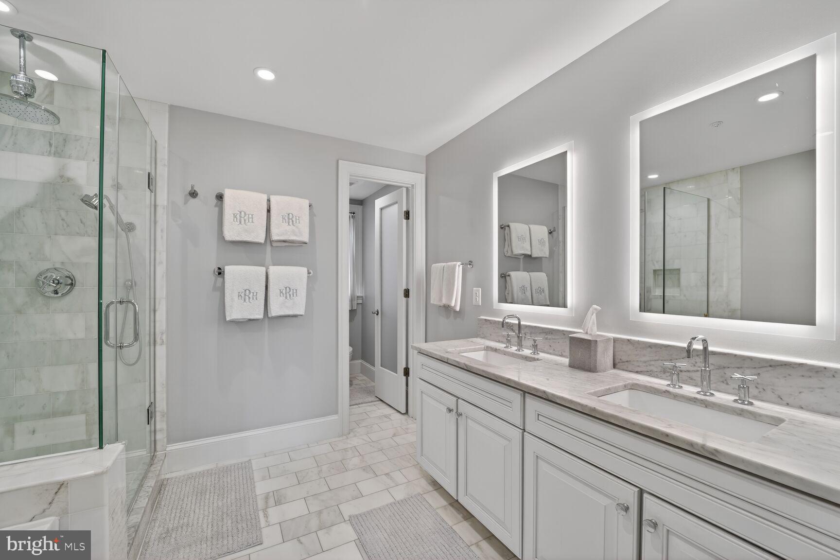 2446 Ontario Road Northwest, Unit 4 Washington, DC 20009 - Photo 30 of 65 a bathroom with a granite countertop sink mirror and double