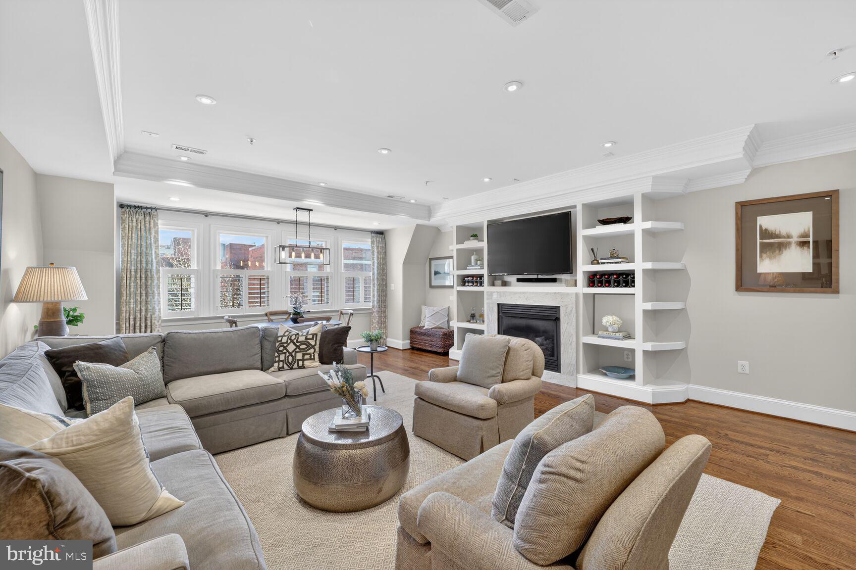 2446 Ontario Road Northwest, Unit 4 Washington, DC 20009 - Photo 3 of 65 a living room with furniture a flat screen tv and wooden floor