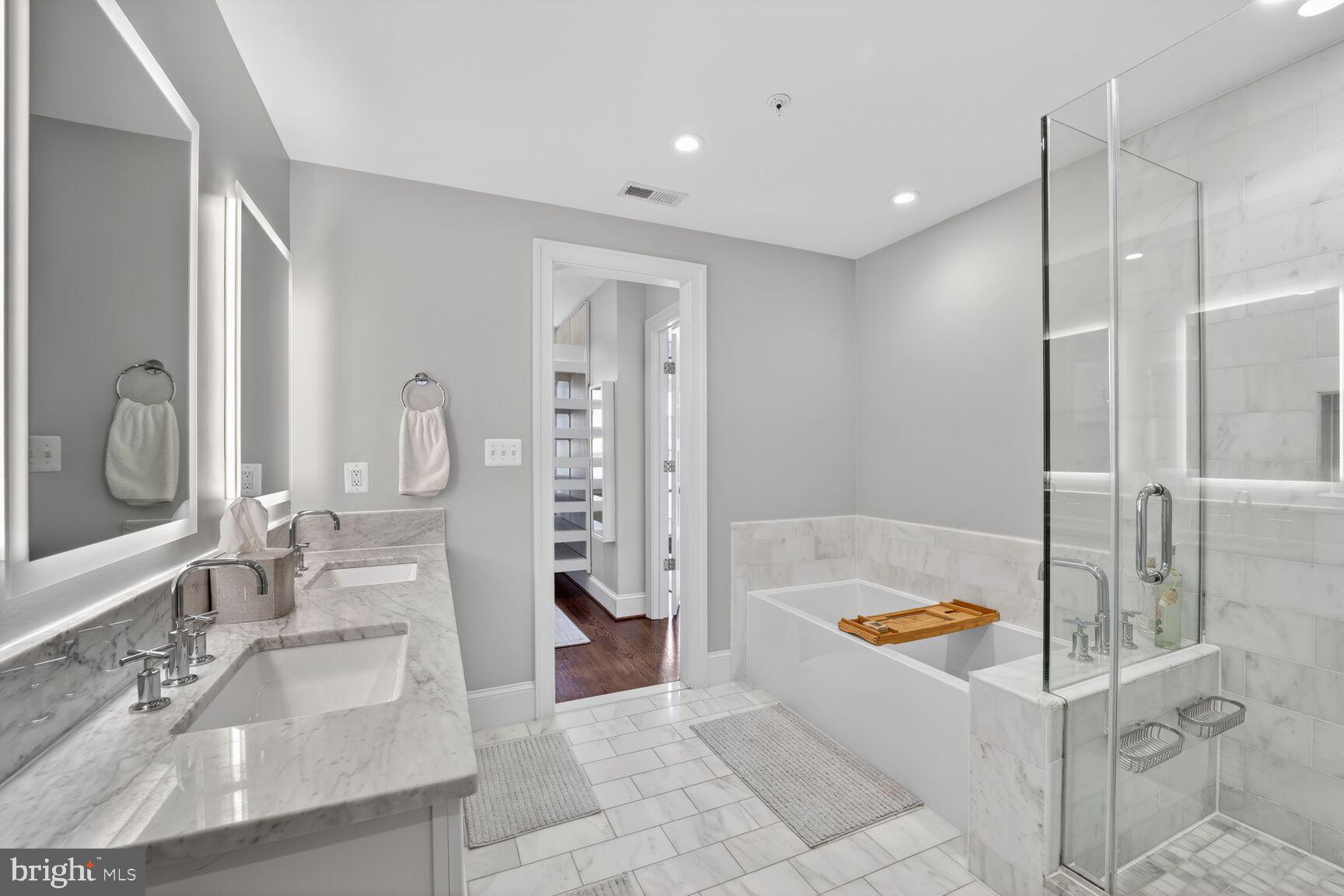 2446 Ontario Road Northwest, Unit 4 Washington, DC 20009 - Photo 31 of 65 a bathroom with a tub sink and mirror
