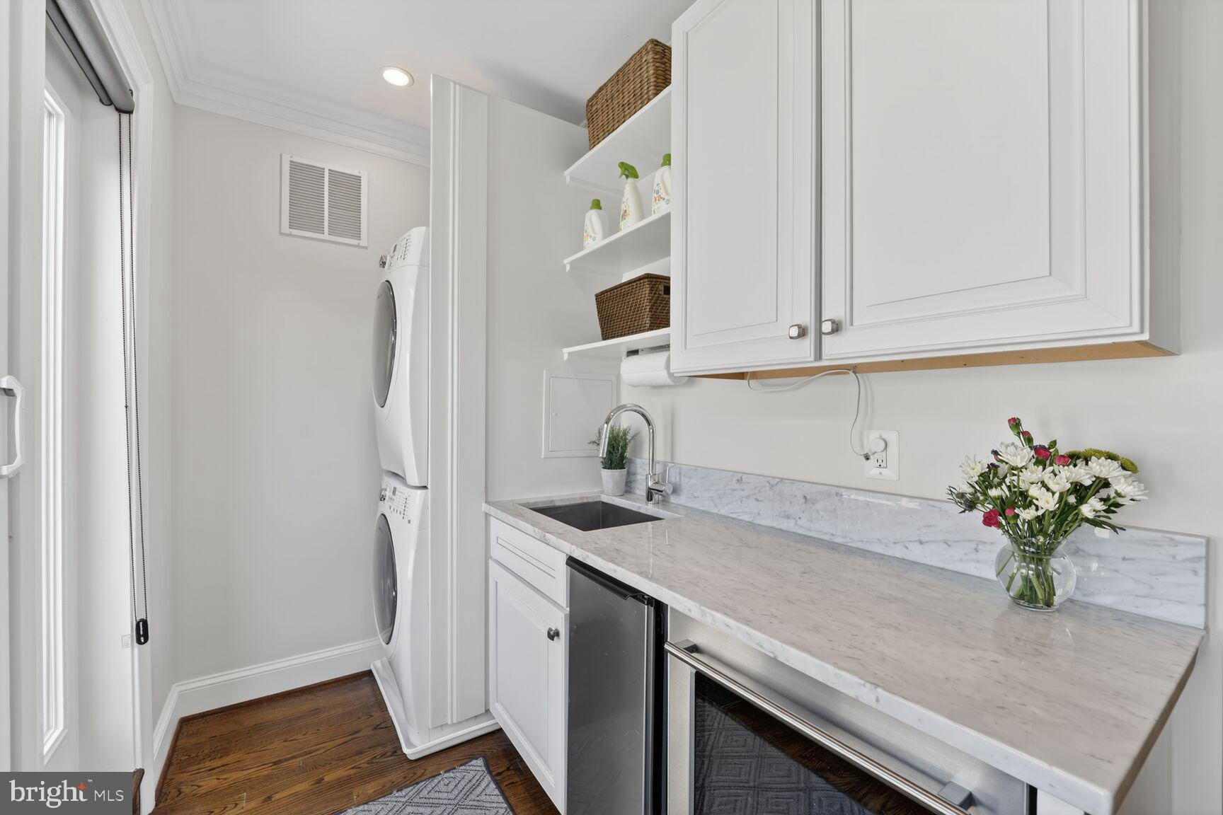 2446 Ontario Road Northwest, Unit 4 Washington, DC 20009 - Photo 34 of 65 a kitchen with stainless steel appliances granite countertop a sink and a white cabinets