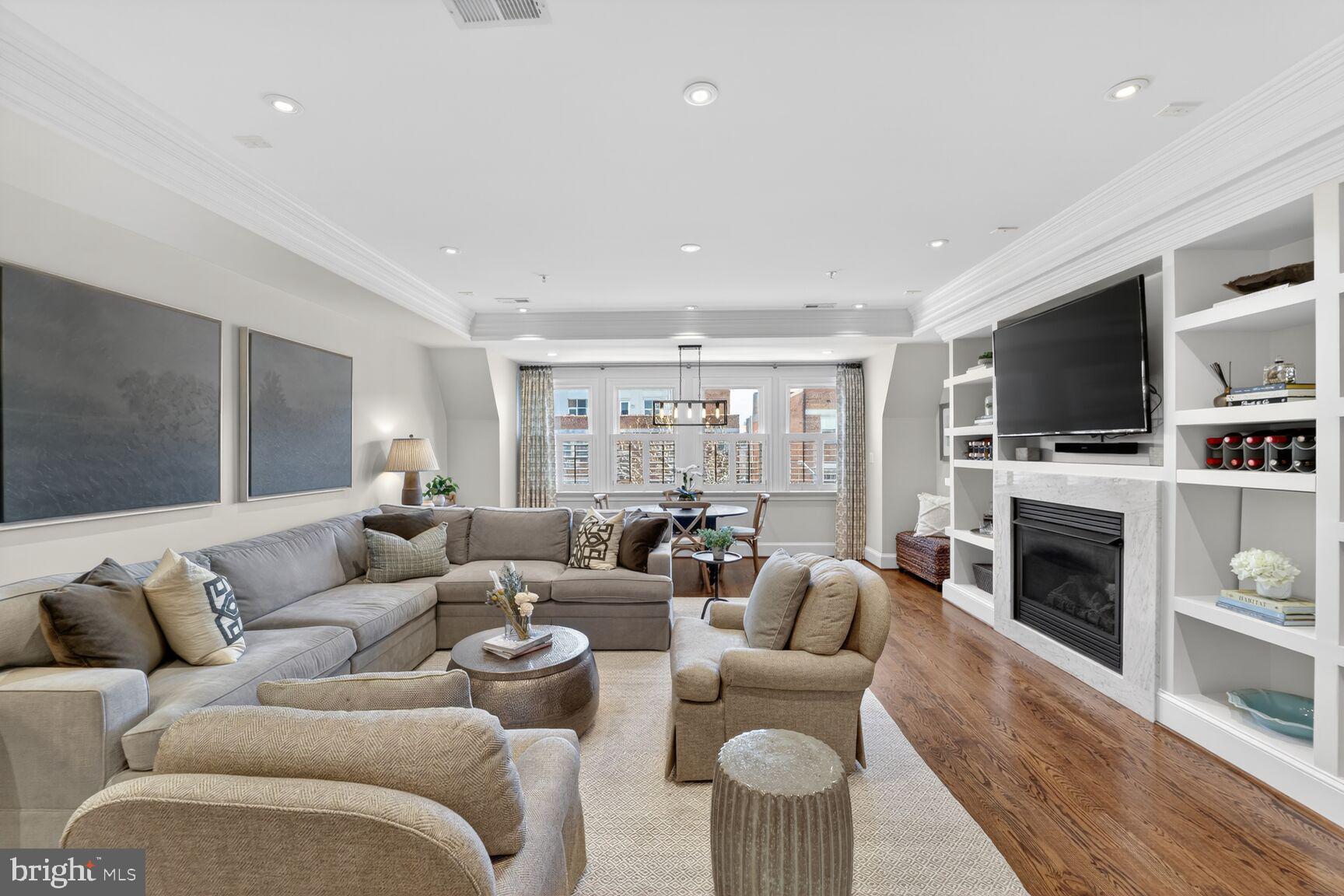 2446 Ontario Road Northwest, Unit 4 Washington, DC 20009 - Photo 4 of 65 a living room with furniture a fireplace and a flat screen tv