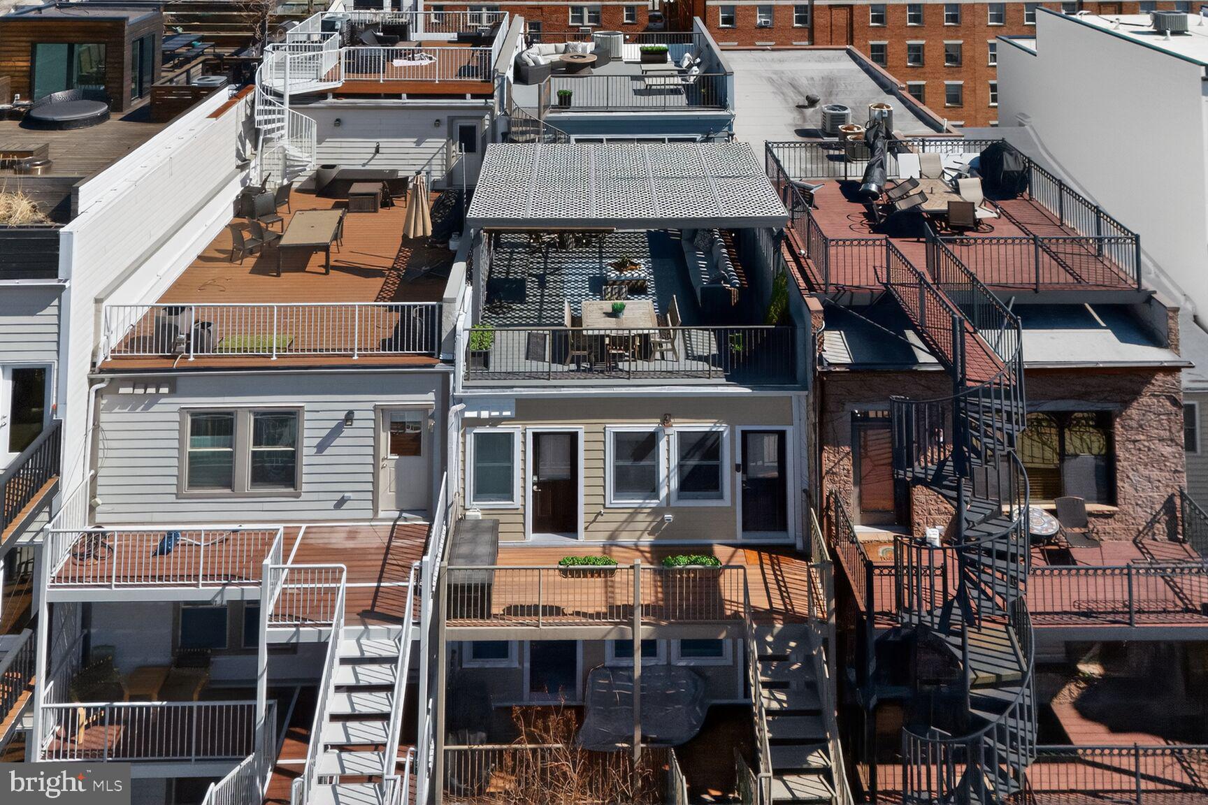 2446 Ontario Road Northwest, Unit 4 Washington, DC 20009 - Photo 42 of 65 a front view of a building with glass windows and a table