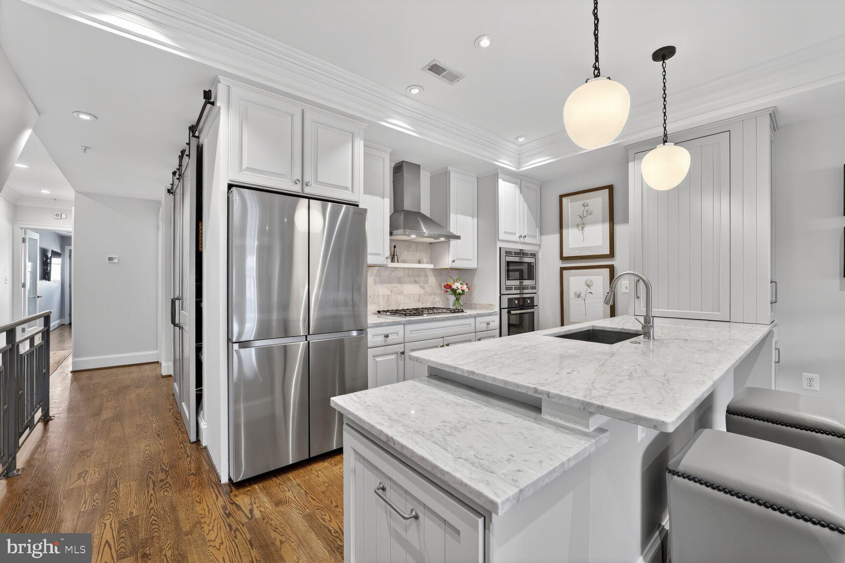 2446 Ontario Road Northwest, Unit 4 Washington, DC 20009 - Photo 5 of 65 a kitchen with a refrigerator a sink and a stove