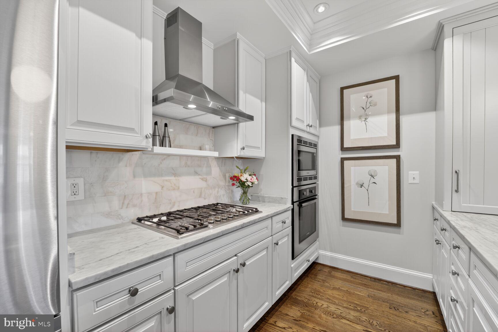 2446 Ontario Road Northwest, Unit 4 Washington, DC 20009 - Photo 7 of 65 a kitchen with stainless steel appliances granite countertop a stove and a refrigerator