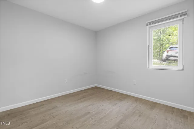an empty room with wooden floor