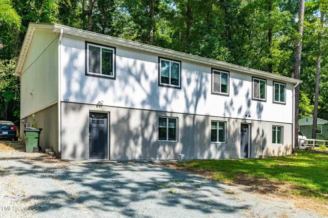 a view of a hallway with wooden floor and entryway