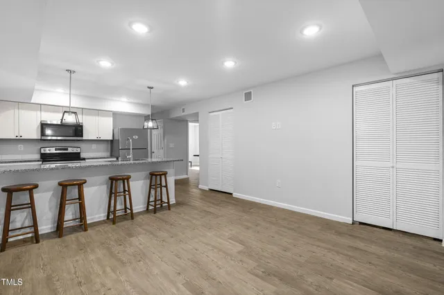 a kitchen with stainless steel appliances a refrigerator and a stove
