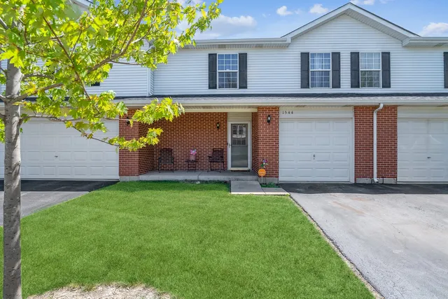 a front view of house with a garden