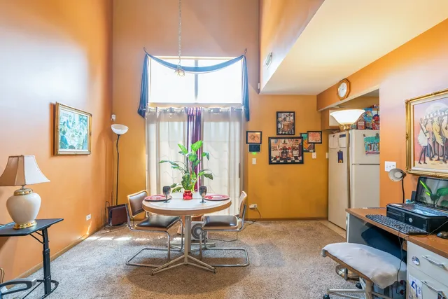 a living room with furniture a rug and a potted plant