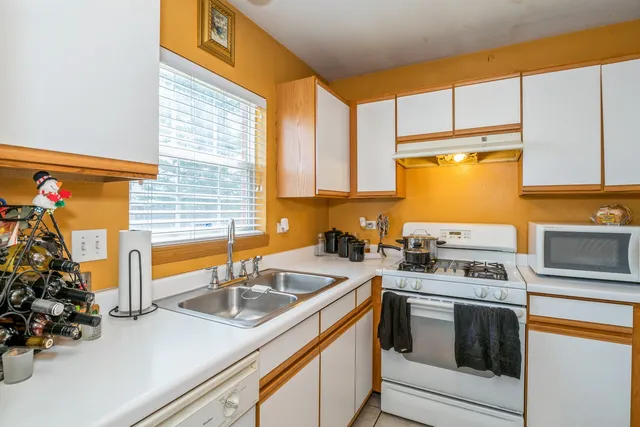 a kitchen that has a sink and a stove