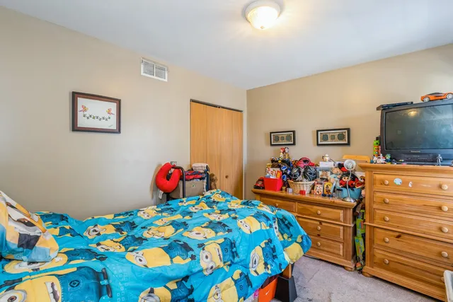 a bedroom with a bed and a tv in it