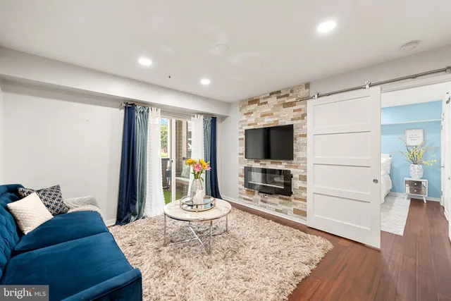 a living room with furniture flat screen tv and a fireplace