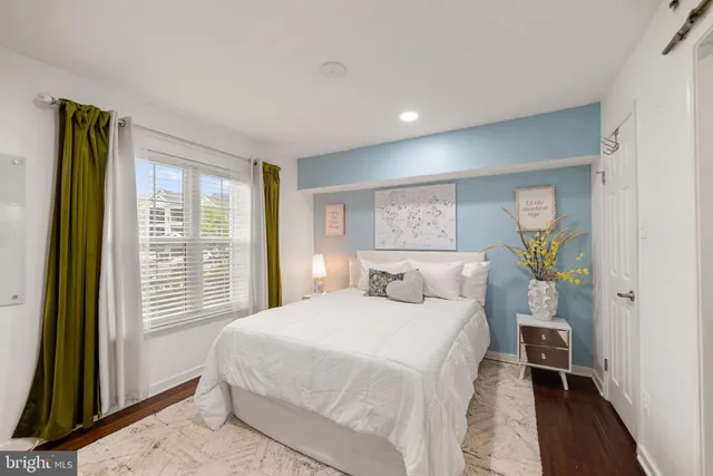 a bedroom with a large bed and a window