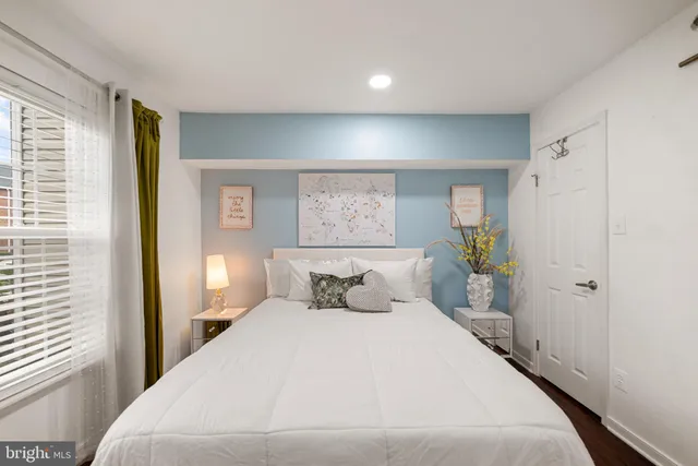 a bedroom with a bed and a window