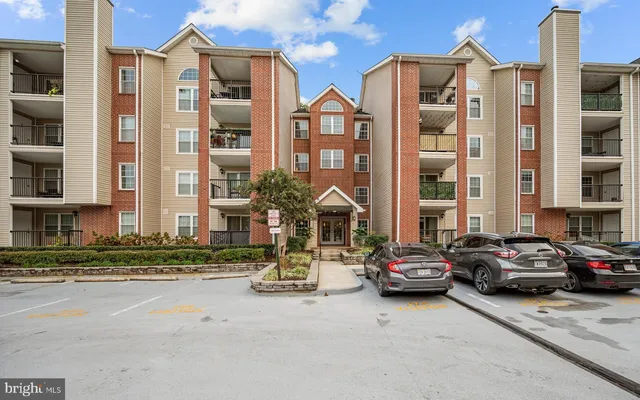 a buildings with car parked in front of it