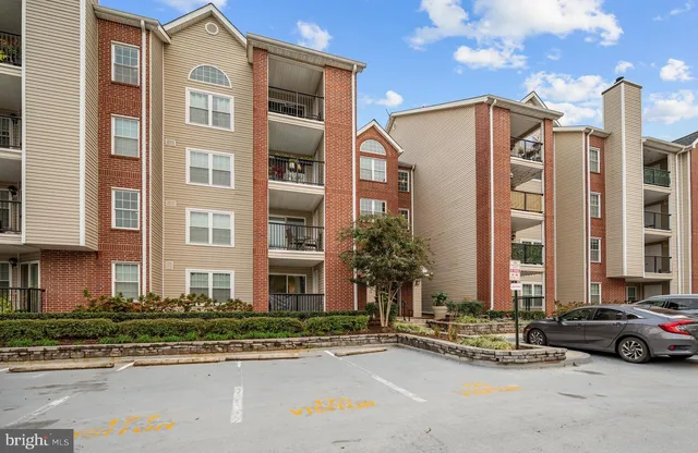 a couple of cars parked in front of a building