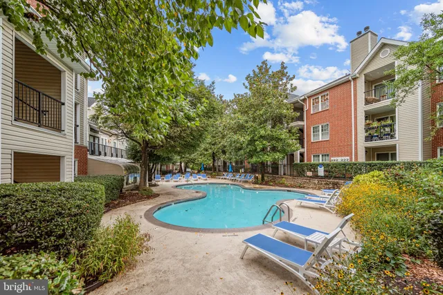 a view of a house with swimming pool and a yard