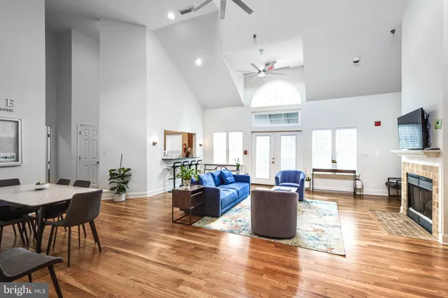a living room with fireplace furniture and a wooden floor