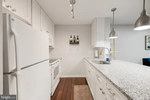 a kitchen with a sink a counter space and appliances